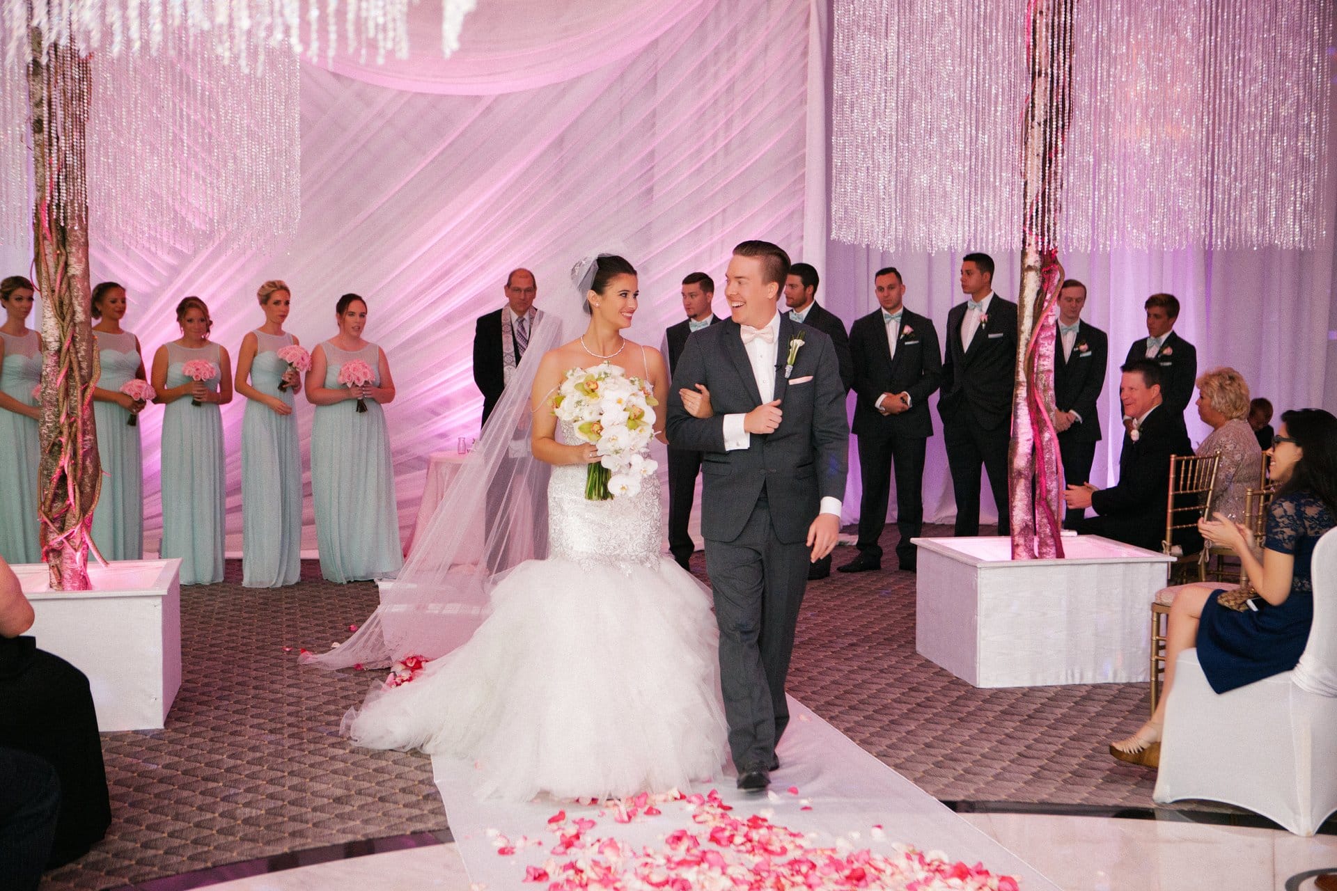 Bride and her father walking the petal aisle
