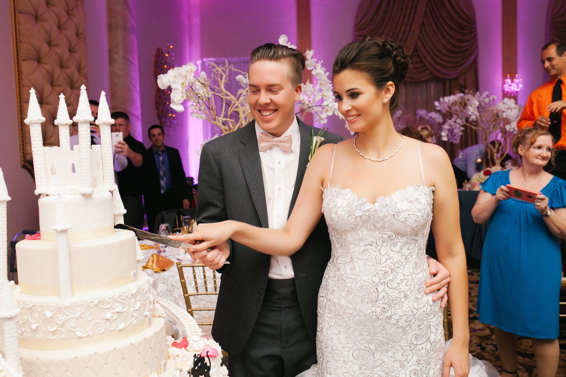 Bride and groom stepping up to cut the cake
