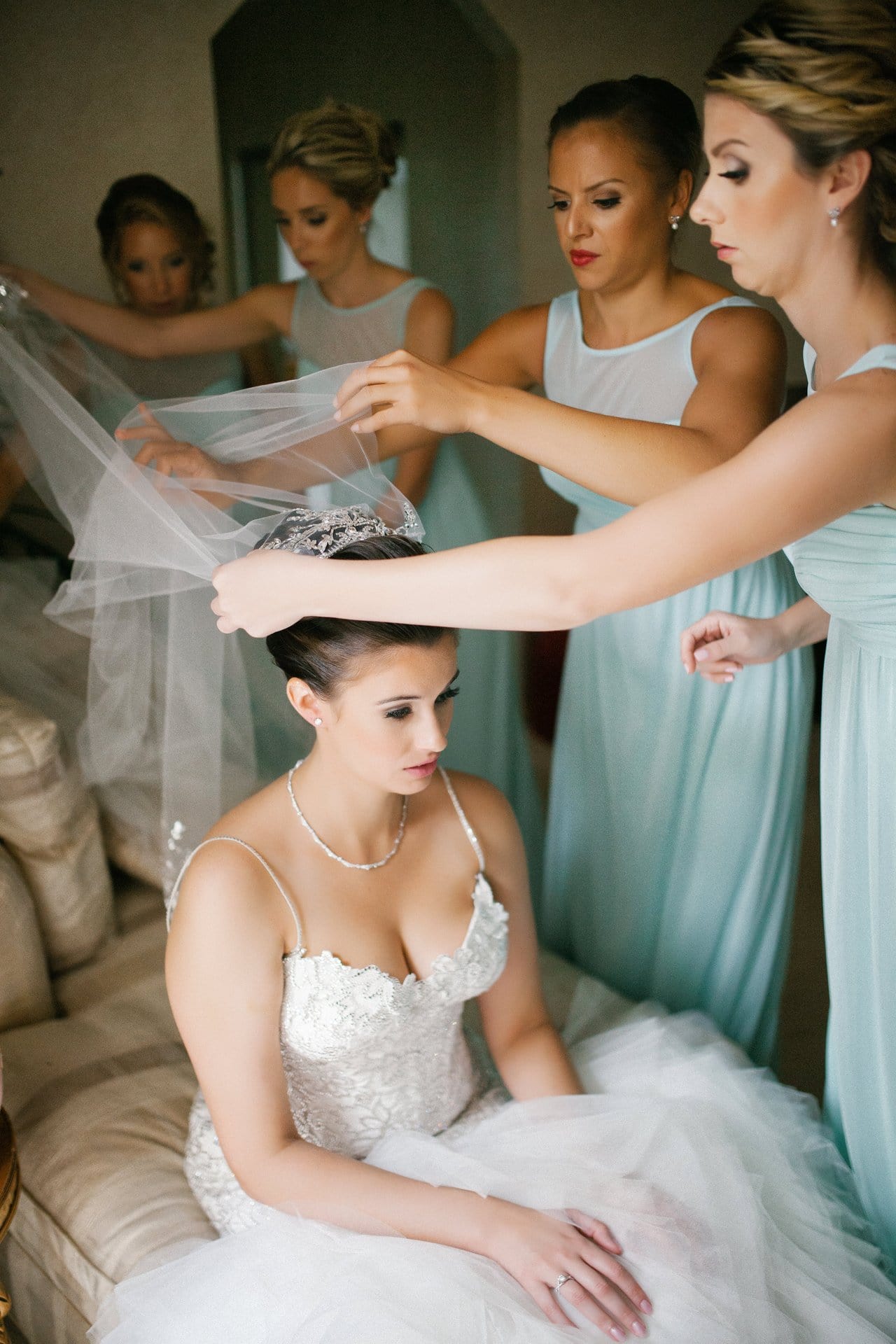 Bridesmaids setting the bride's cathedral veil