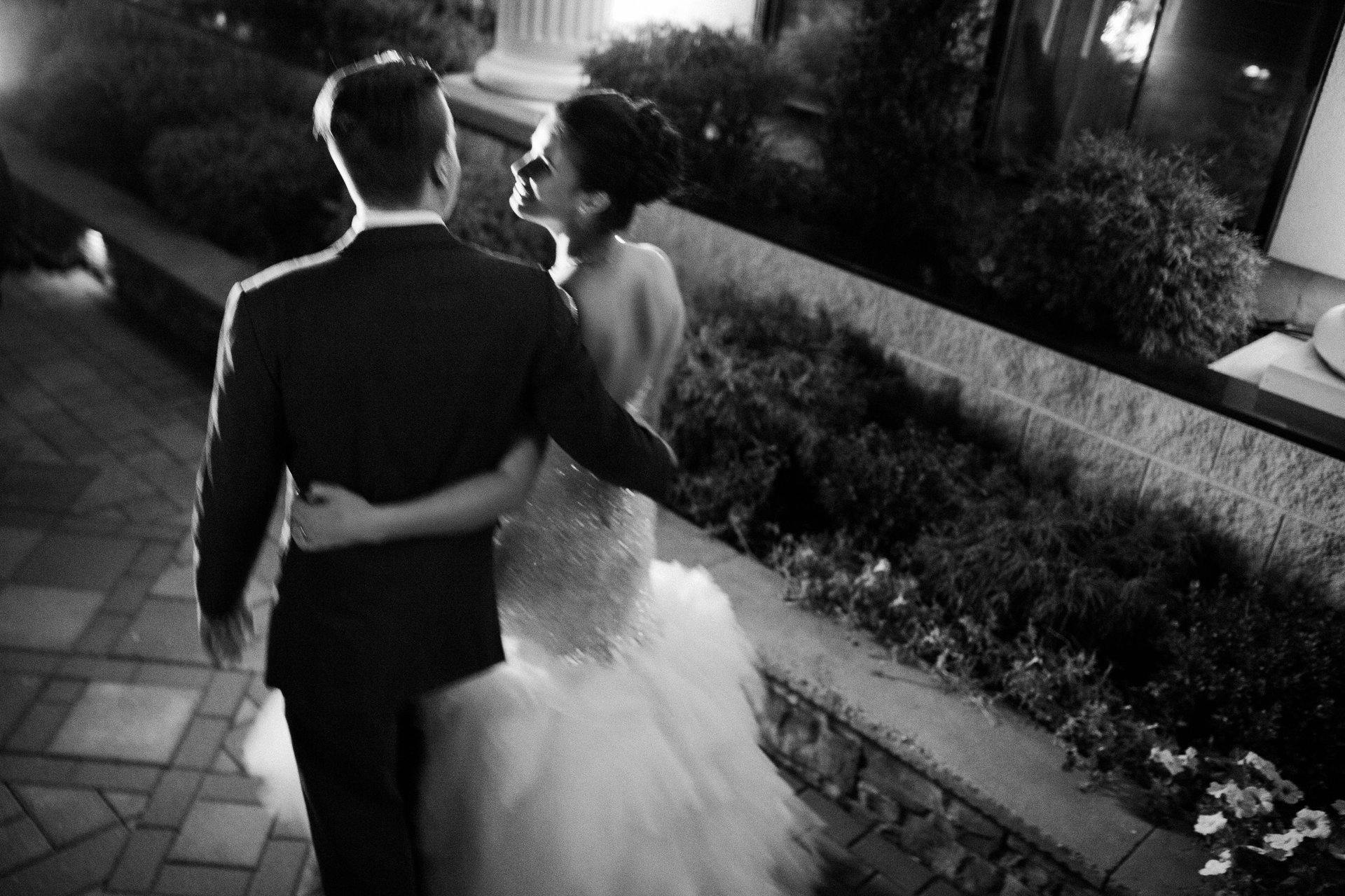 Bride and groom outside at night in black and white