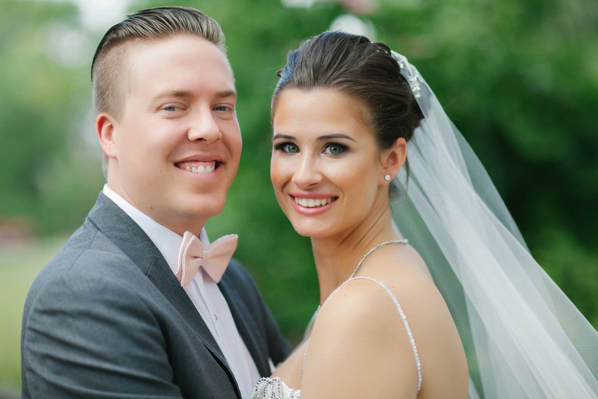 Bride and groom cheek to cheek at Berlin Park