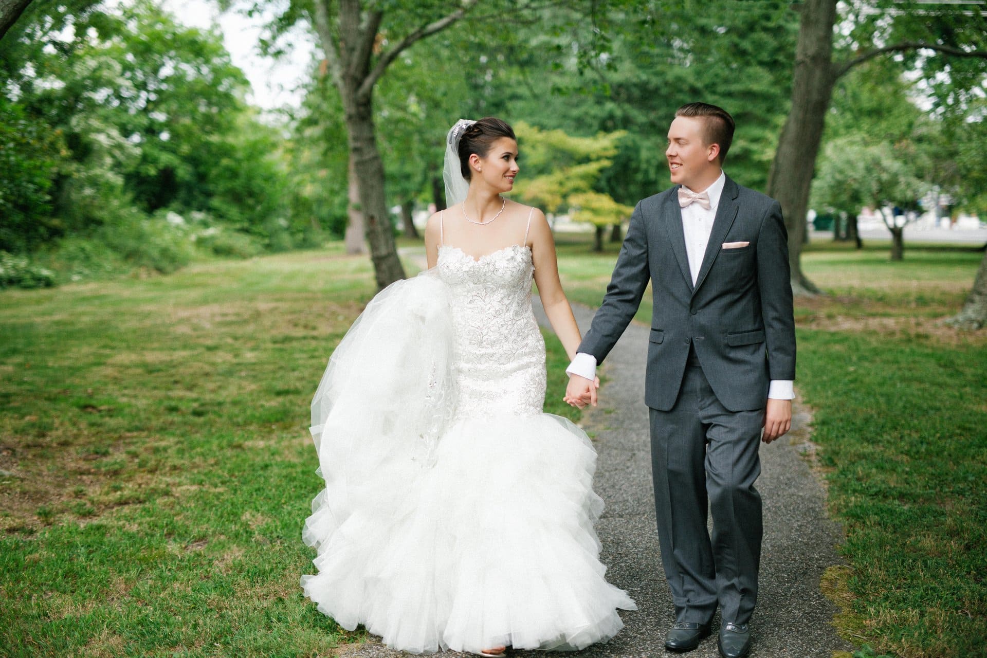 Bride and groom walking hand in hand through Berlin Park