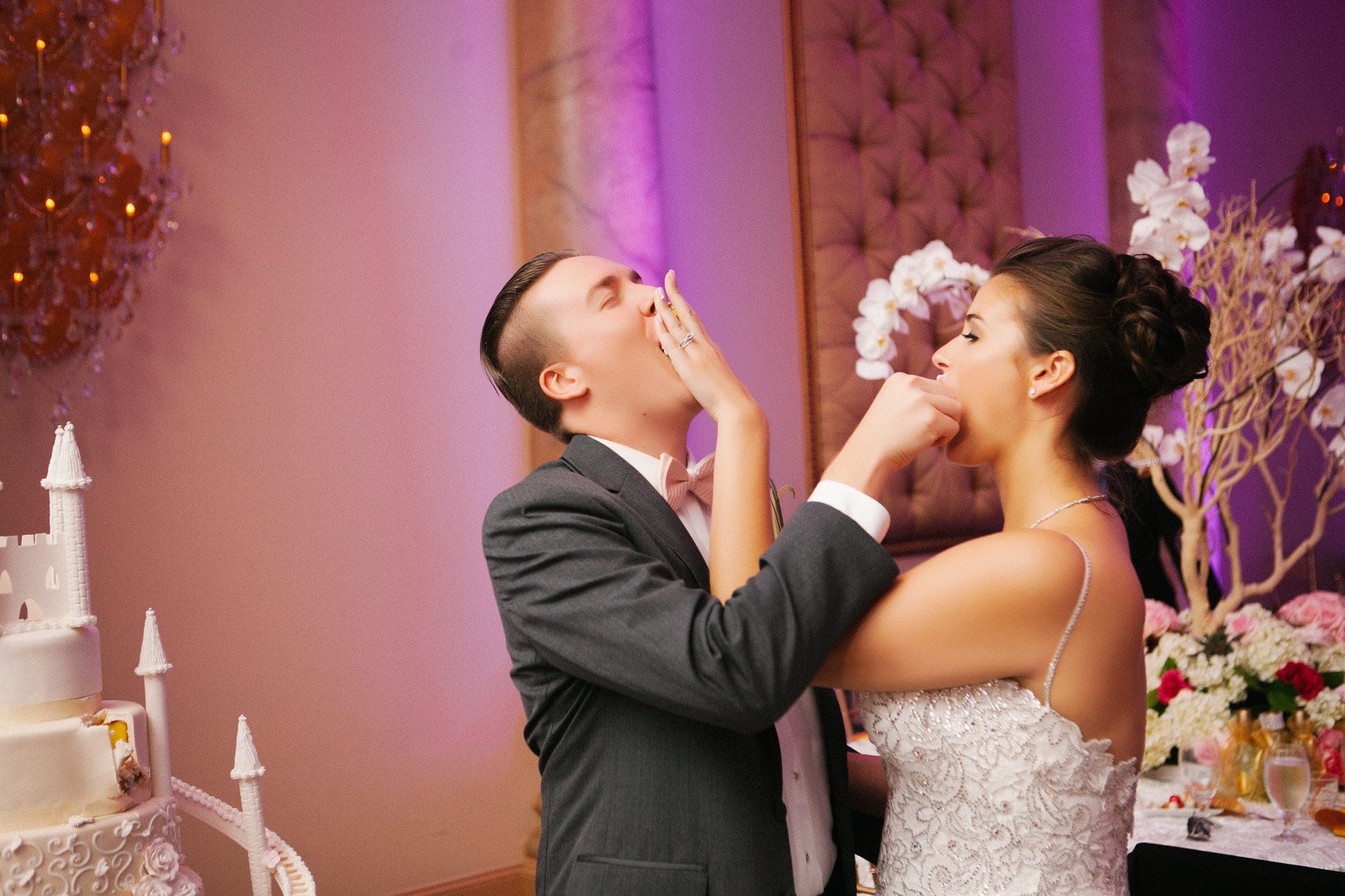 Bride and groom feeding each other cake