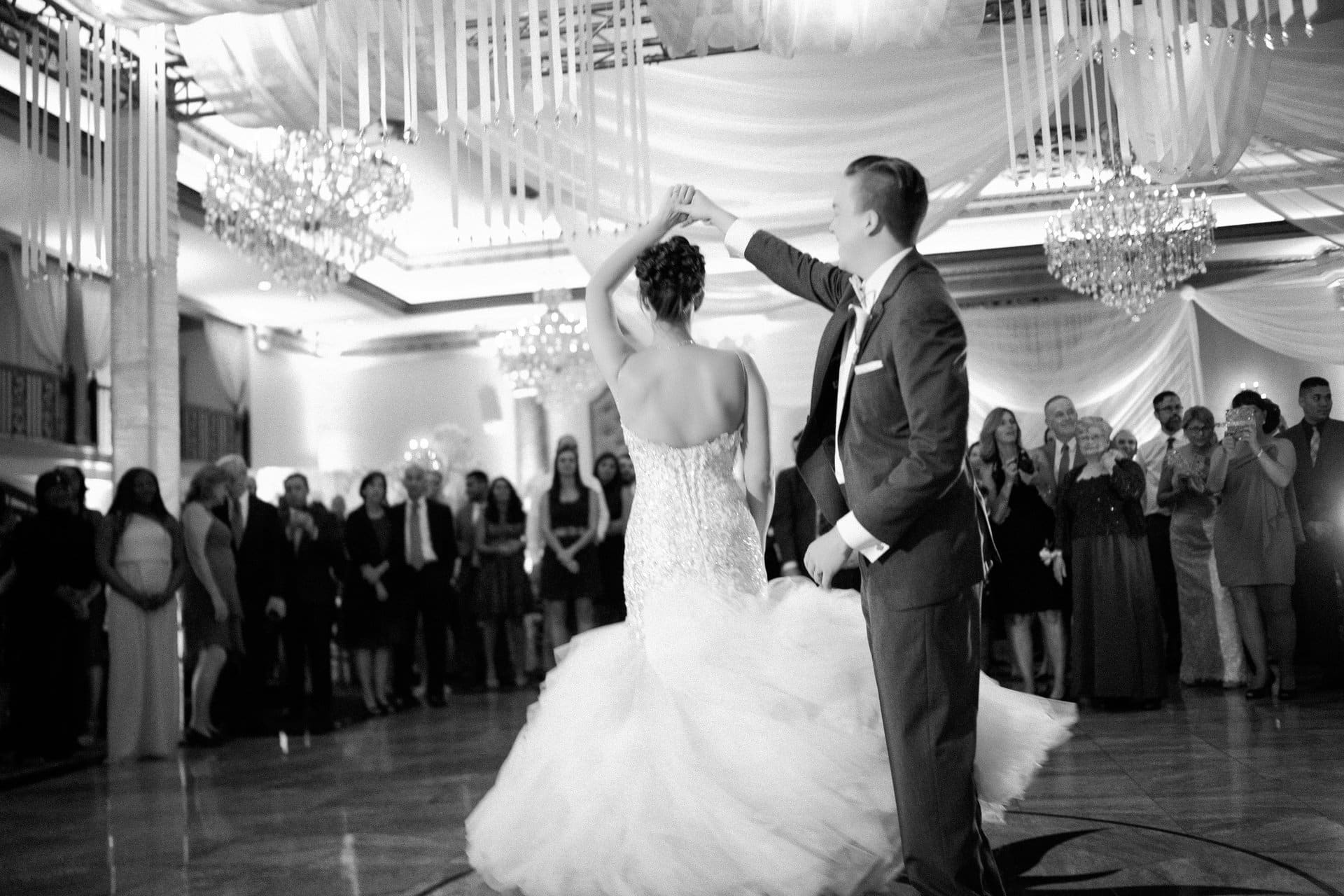 Groom spinning the bride during their first dance