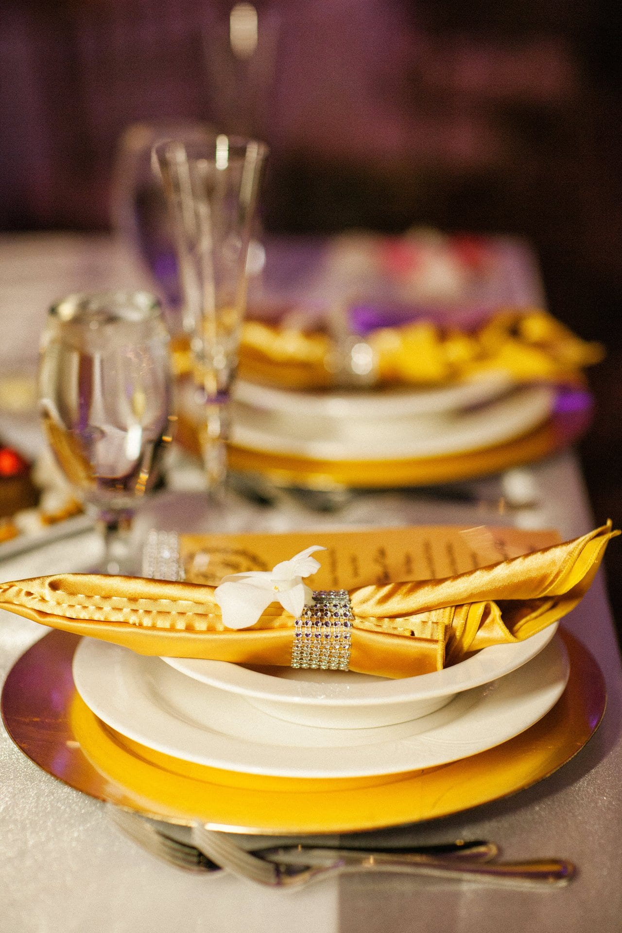 Gold place setting and folded napkin detail