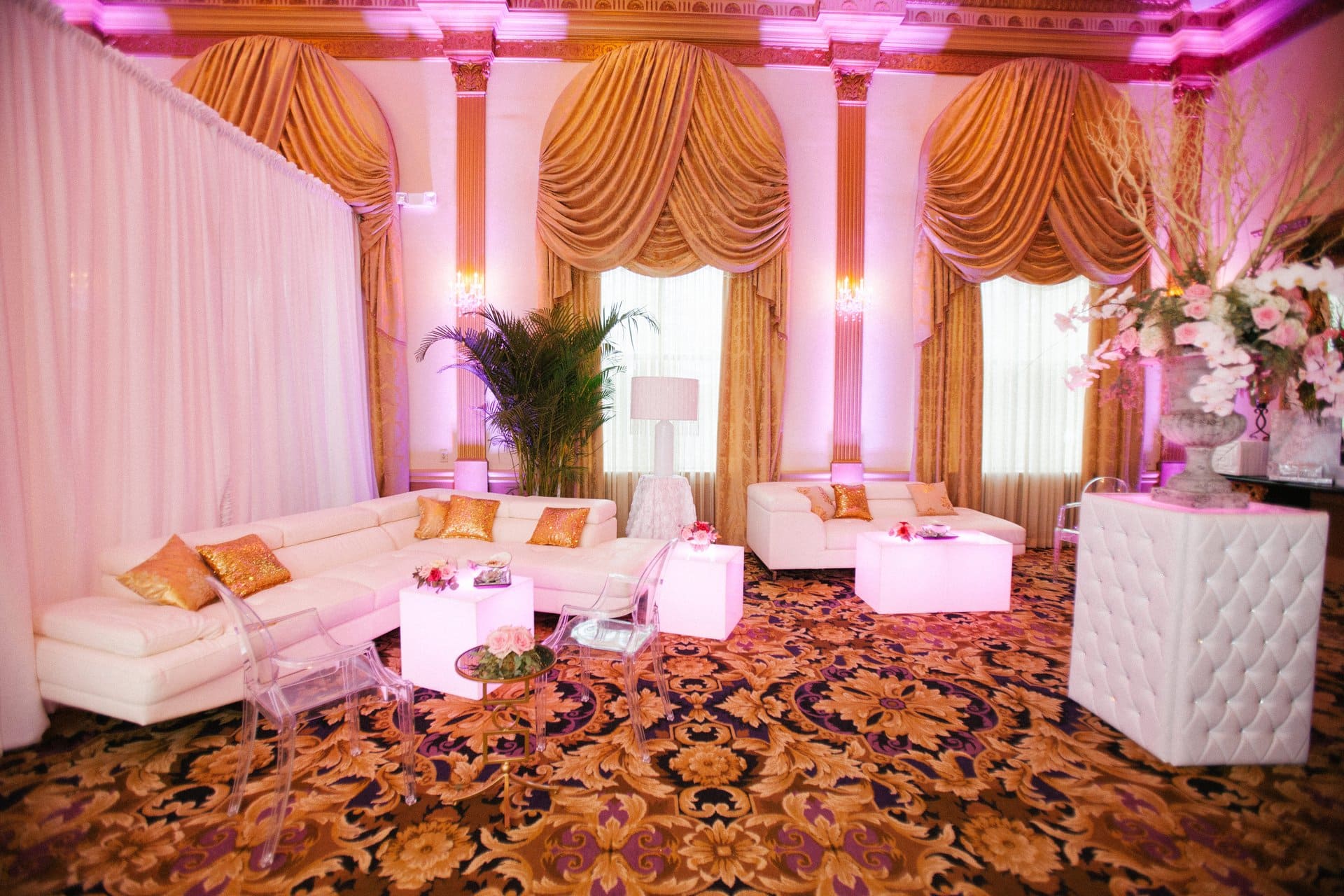 White lounge furniture set up in a draped side room