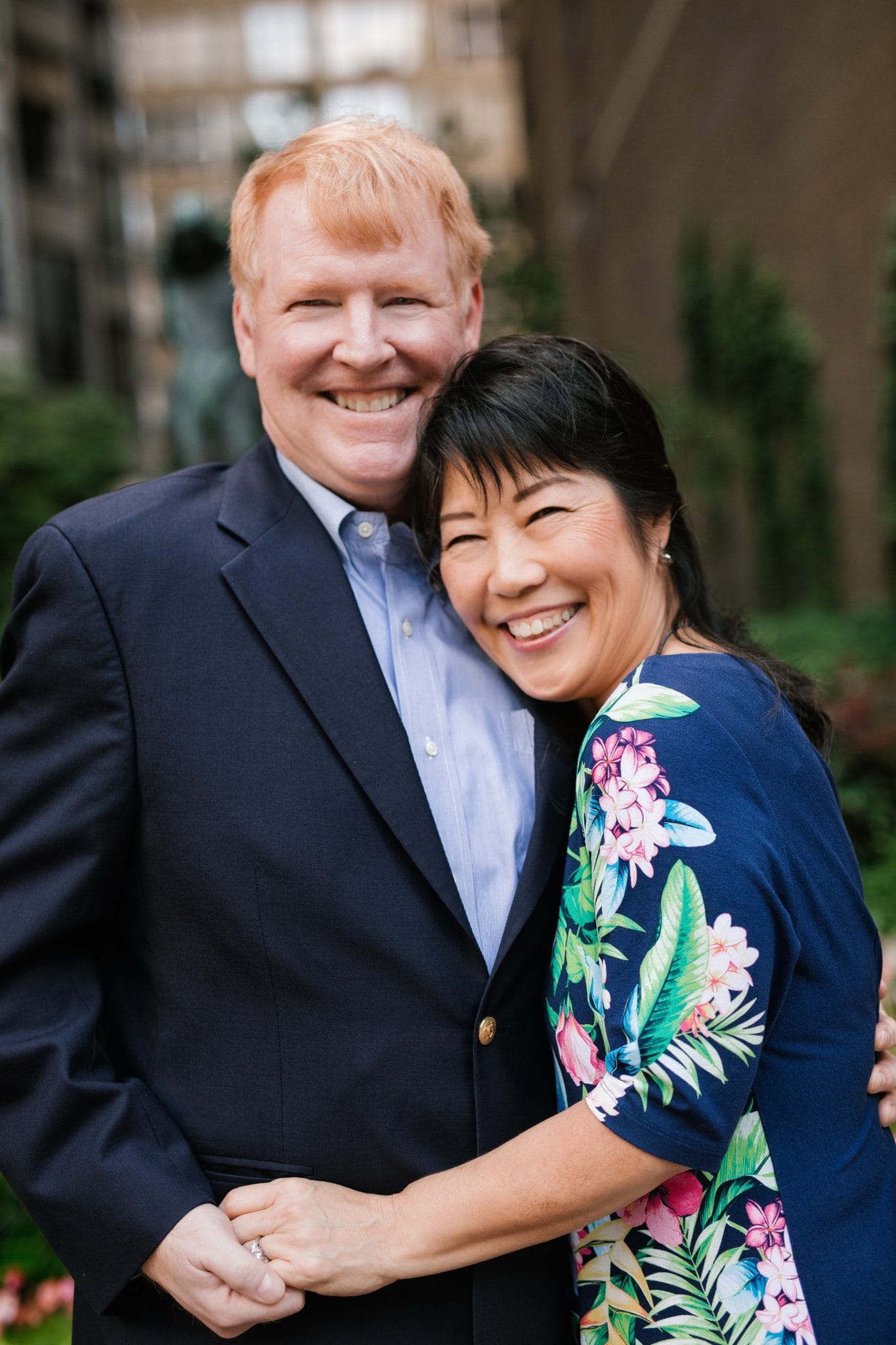 A husband and wife holding each other during family portraits at The Rittenhouse in Philadelphia