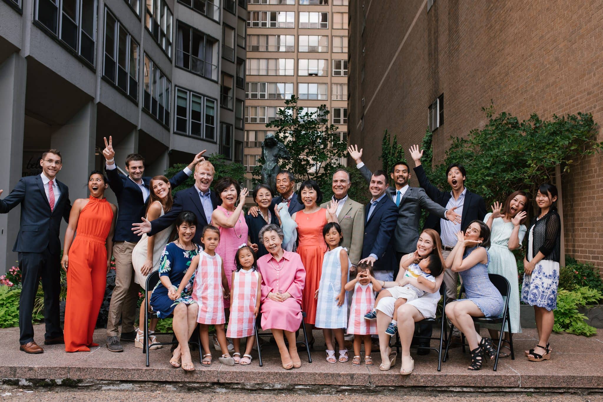 Hands in the air as an extended family celebrates a new engagement in Philadelphia
