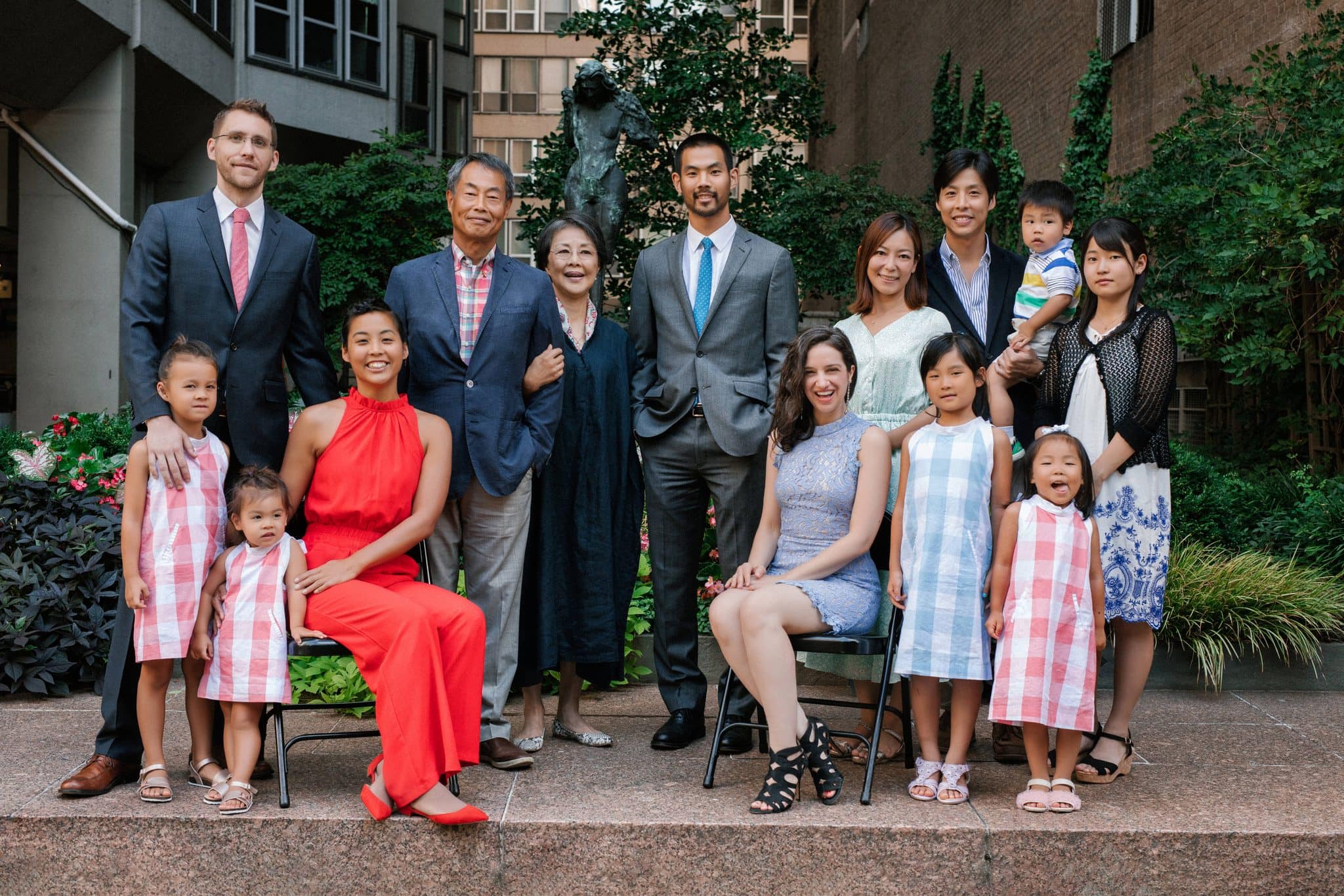A large extended family gathered for a reunion portrait in the courtyard at The Rittenhouse in Philadelphia
