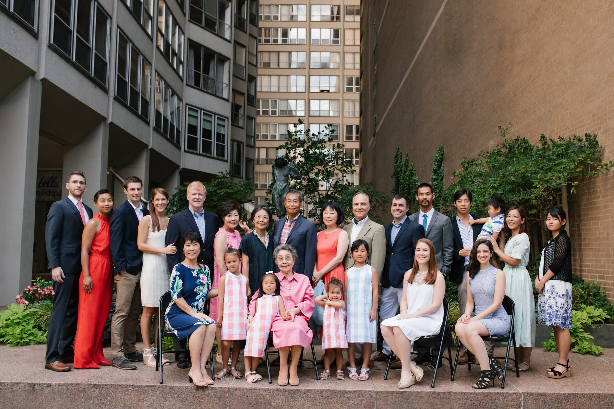 The full extended family arranged with chairs for a large group portrait at The Rittenhouse in Philadelphia