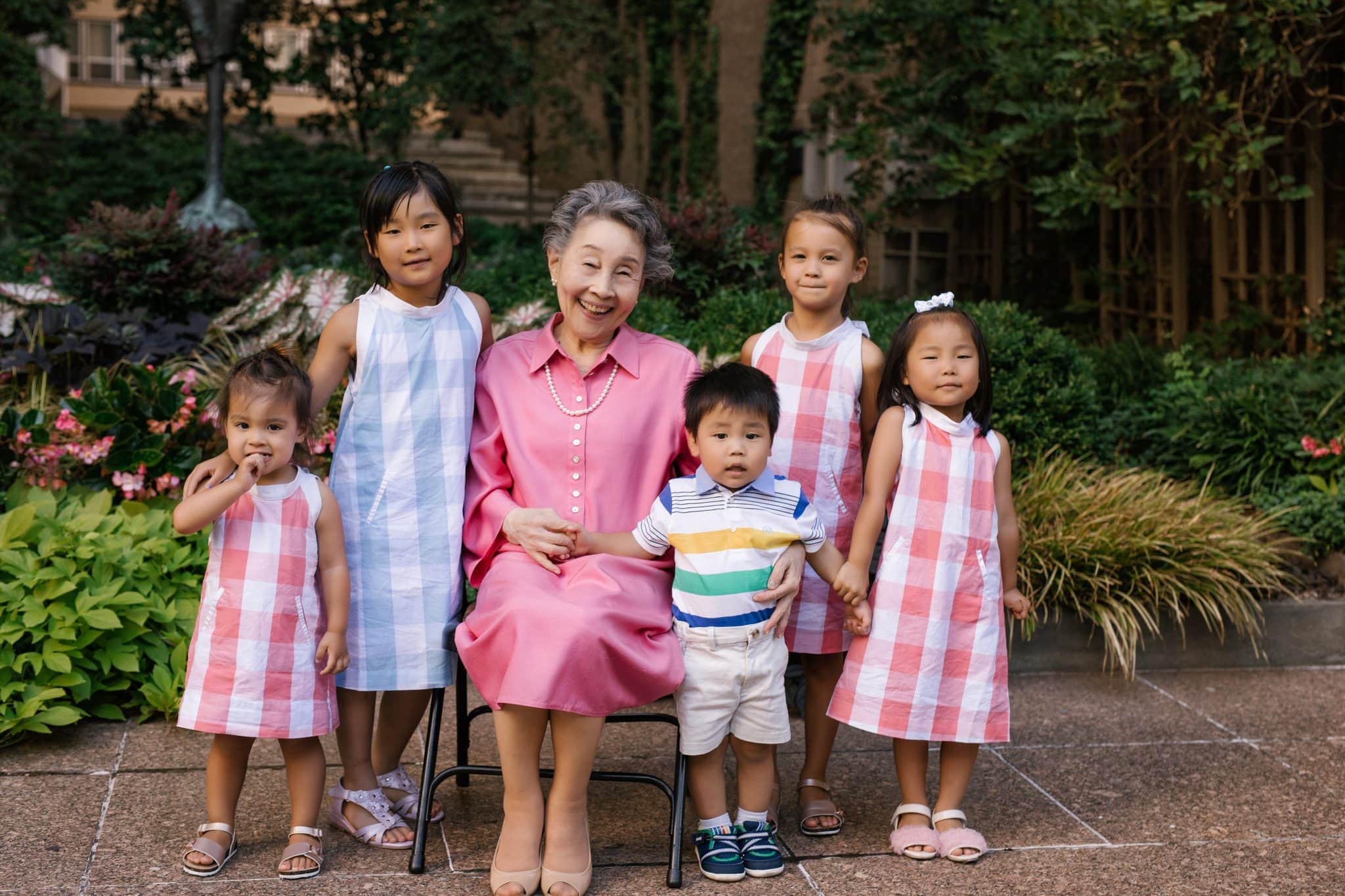 A grandmother surrounded by her grandchildren in the courtyard at The Rittenhouse in Philadelphia
