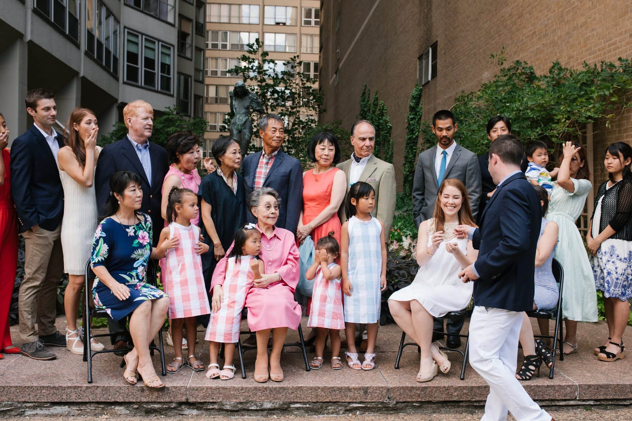 A man stepping into the family group portrait moments before a surprise proposal in Philadelphia