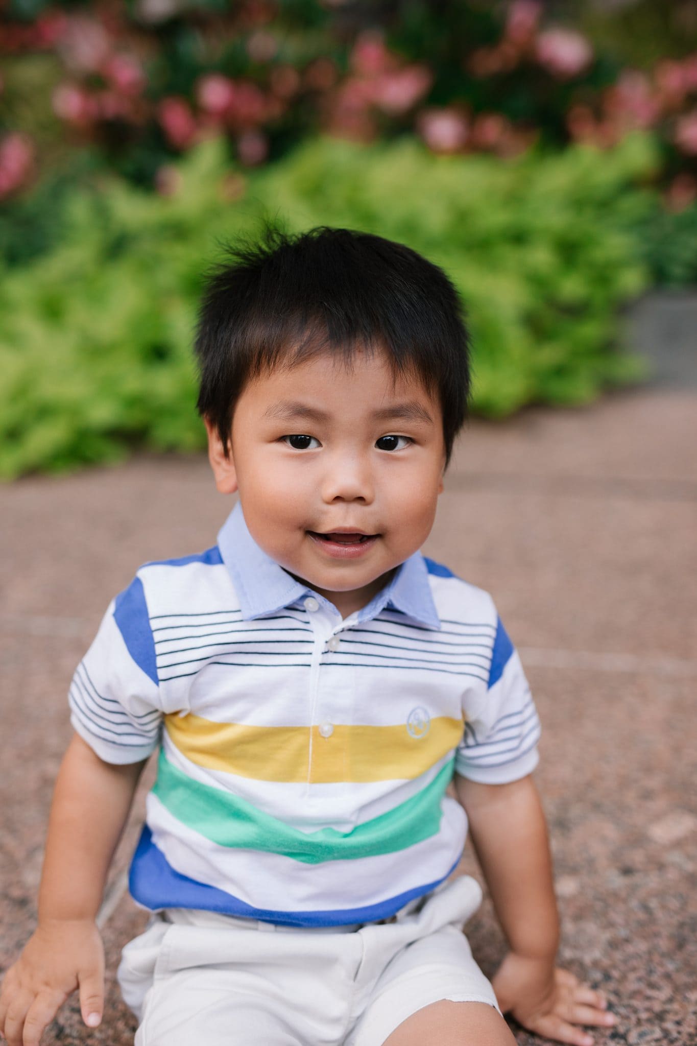 A young boy in a striped shirt smiling during a family reunion session in Philadelphia